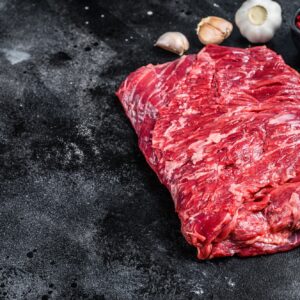Raw fresh marble beef brisket meat with herbs. Black background. Top view. Copy space